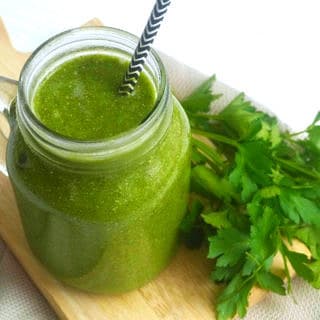 Detoxifying Clean Green Smoothie by Nourish Everyday -A detoxifying dairy free green smoothie blending together lots of greens with coconut water, ginger, chia and flaxseed.