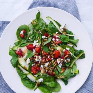 Balsamic Strawberry and Spinach Salad - gluten free and grain free. Topped with crunchy toasted pumpkin seeds and feta - so good!
