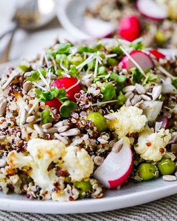 This gorgeous pea and cauliflower quinoa pilaf is packed full of healthy vegetables. Vegan, gluten free and sugar free. The perfect side dish! Recipe via wordpress-6440-15949-223058.cloudwaysapps.com