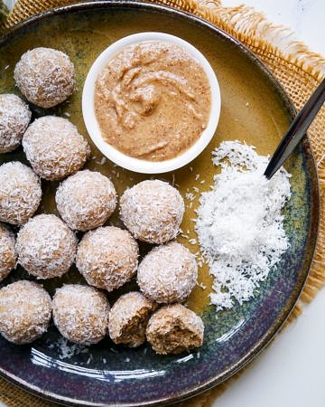 Healthy protein balls with peanut butter and coconut on a blue ceramic plate