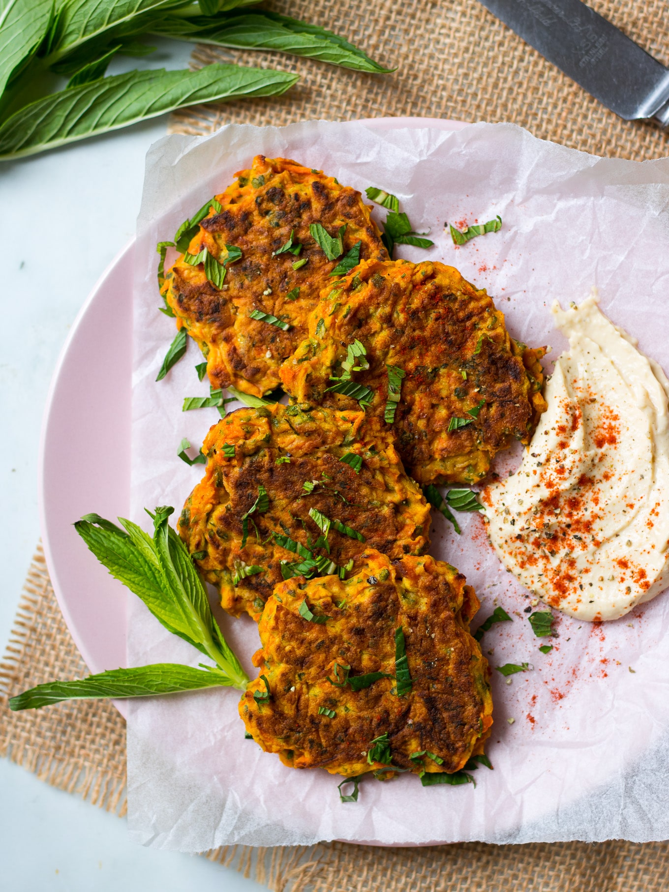 carrot fritters arranged on a pink plate