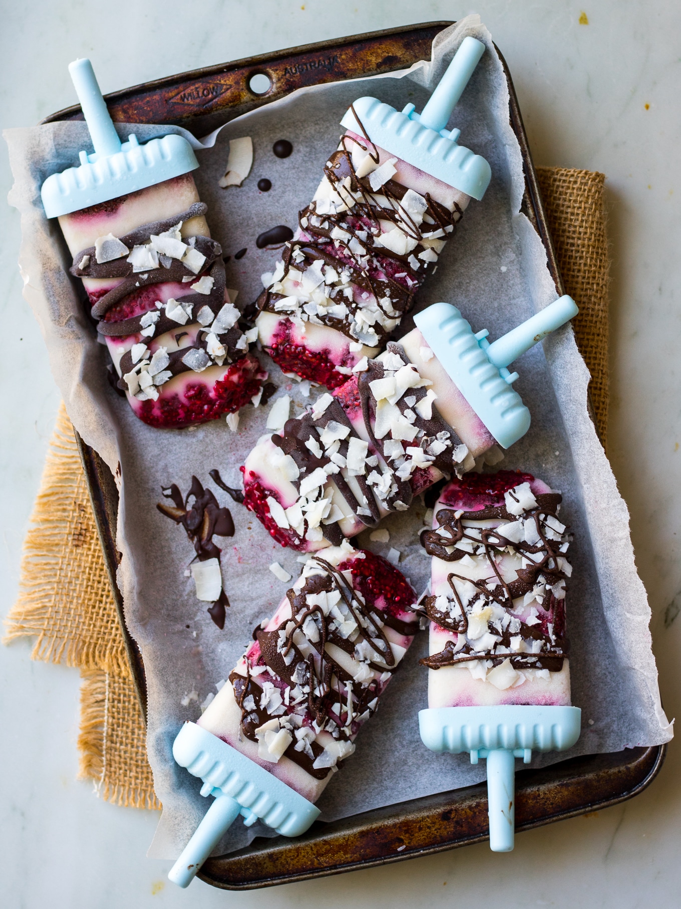 Creamy coconut #lamington popsicles are a healthy vegan frozen dessert, made with coconut yoghurt, raspberry chia jam and dark chocolate. Easy to make! #dairyfree #popsicles #vegan