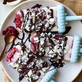 Creamy coconut lamington popiscles with raspberry chia jam, dark chocolate and coconut flakes. These dairy free, vegan frozen treats are a fun healthy way to get a lamington fix! #popsicles #lamington #vegan