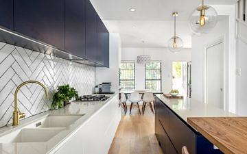 Terrace kitchen renovation (white and navy cabinets, subway tiles, kitchen island)