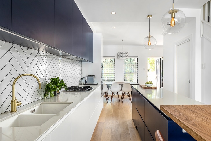 Terrace kitchen renovation (white and navy cabinets, subway tiles, kitchen island)