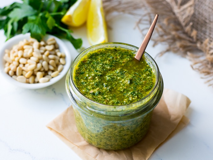 Lemon basil pesto in a small glass jar with spoon