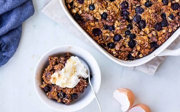 coconut blueberry baked oats with Greek yoghurt dish and serving bowl