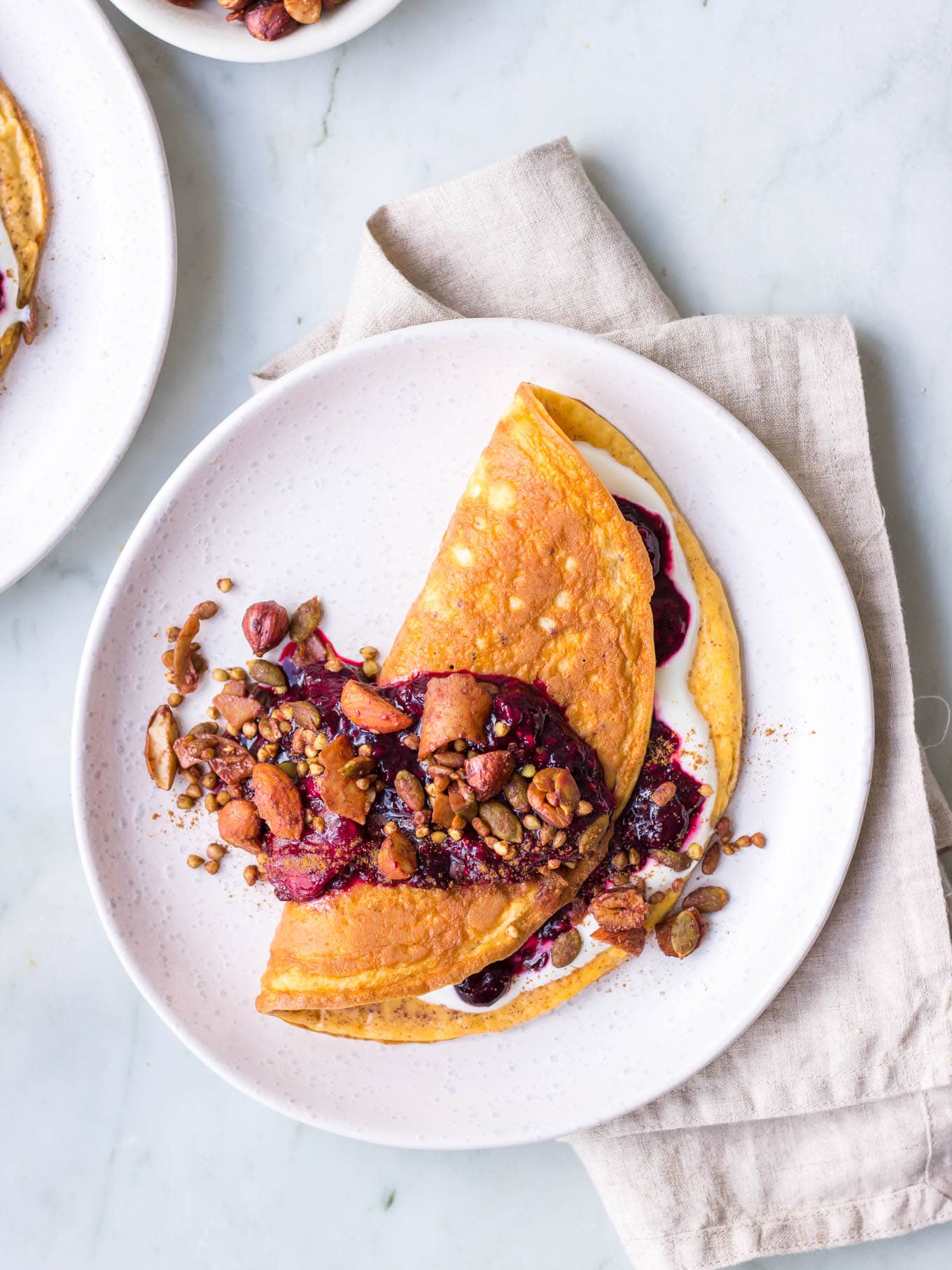 Sweet cinnamon omelette with berry compote and granola topping