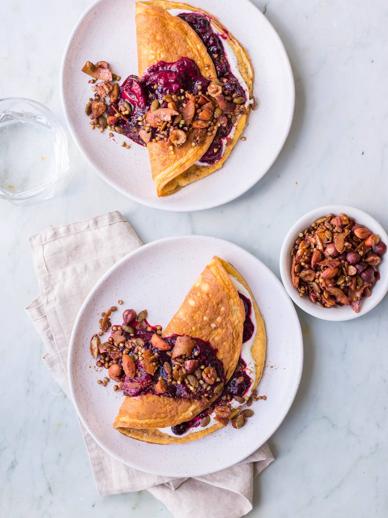 Sweet cinnamon omelettes with berry compote and granola topping