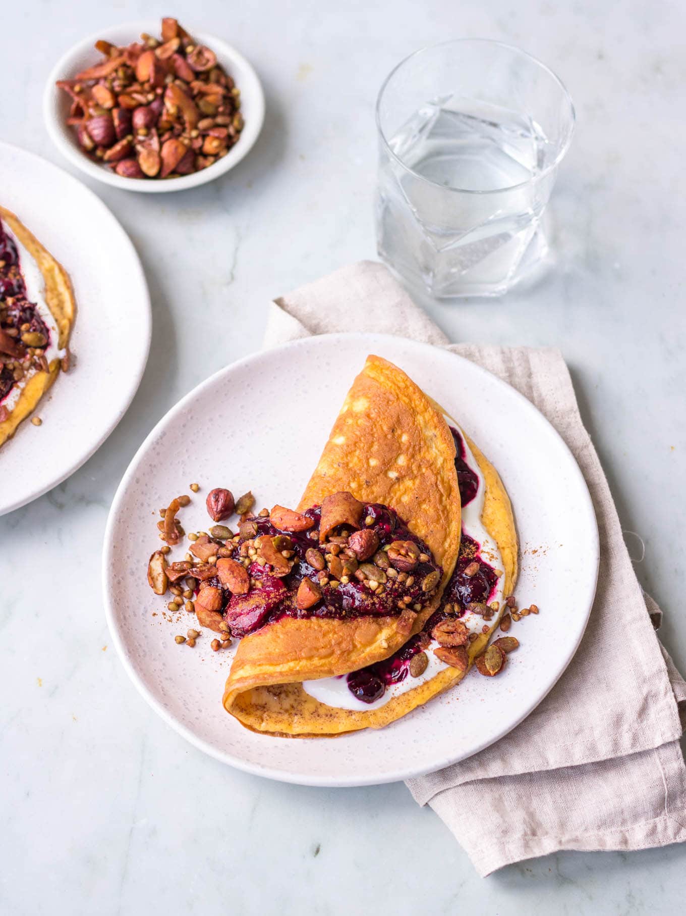 Sweet cinnamon omelette with berry compote and granola topping
