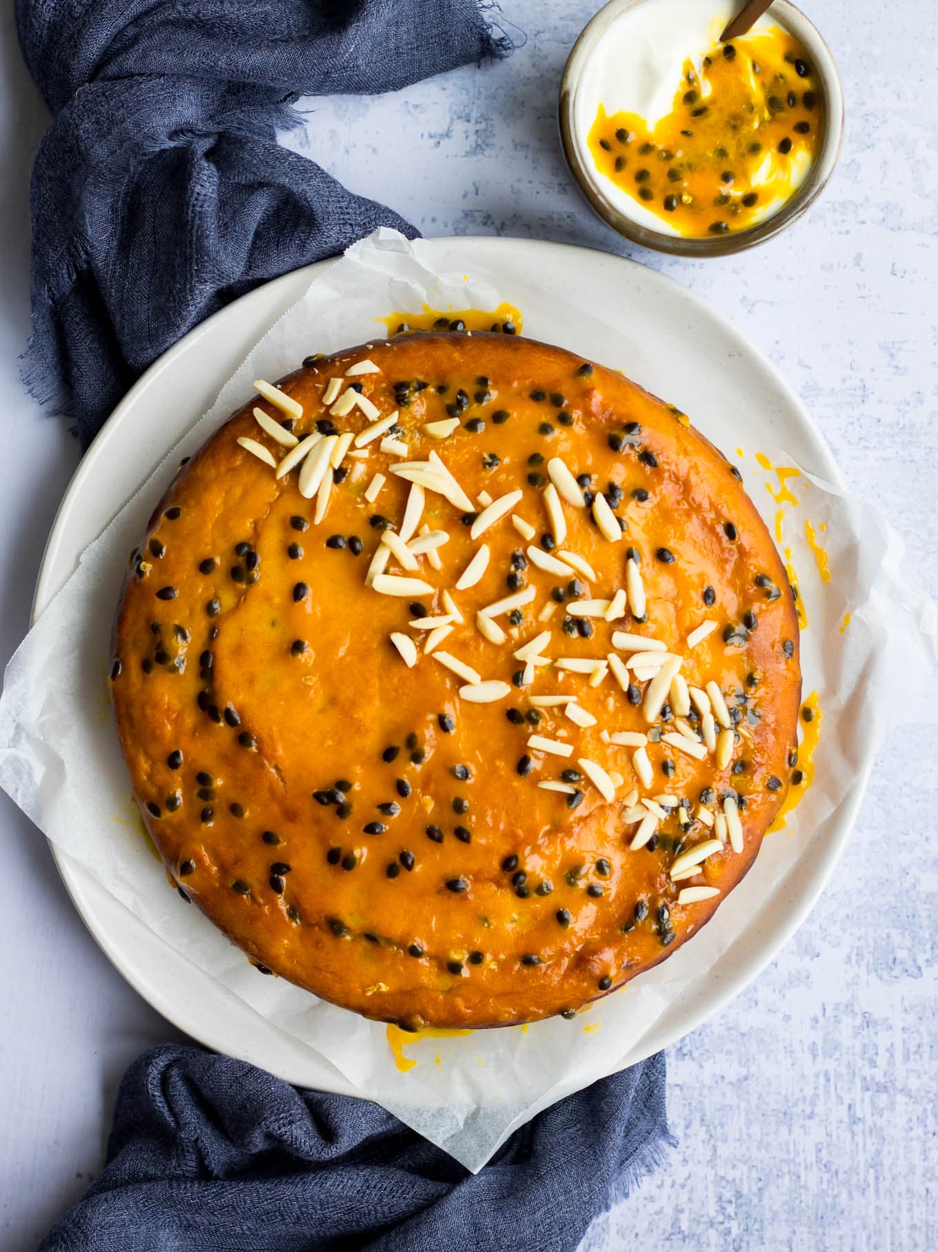 passionfruit yoghurt cake with passionfruit glaze and almonds