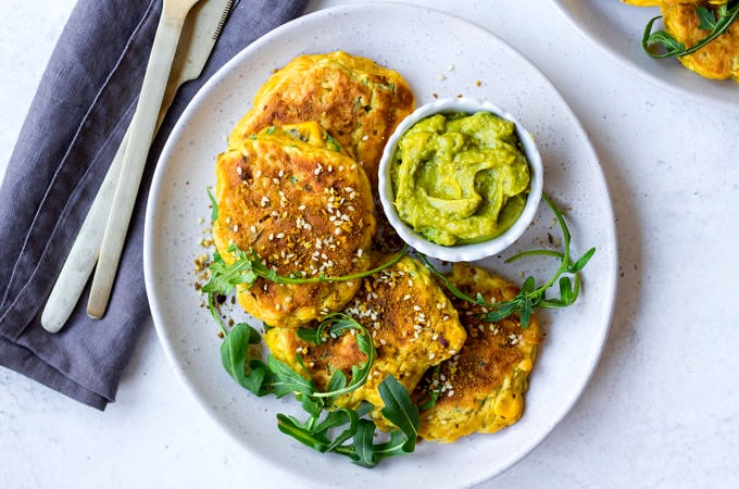 Gluten Free Corn Fritters arranged with rocket on grey ceramic plate | Nourish Every Day Blog