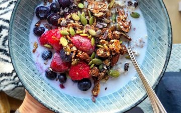 Granola bowl with fruit and fortified plant milk by Nourish Every Day