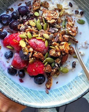 Granola bowl with fruit and fortified plant milk by Nourish Every Day