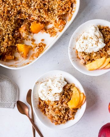Gluten free nectarine crumble topped with yoghurt and cinnamon
