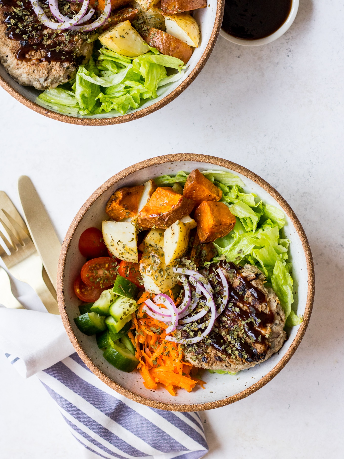 Turkey burger patty in a bowl with salad