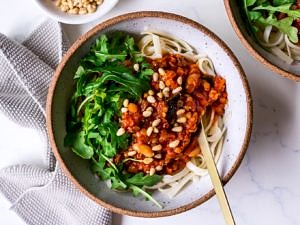 Vegan bolognese sauce topped with pine nuts