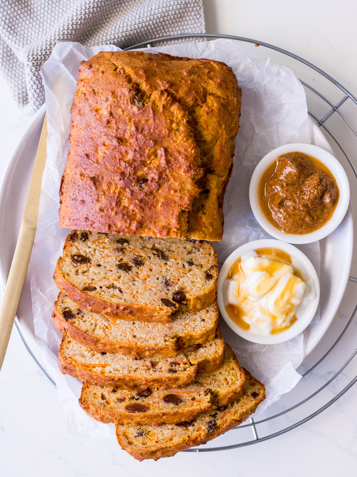 Banana, carrot and sultana loaf cake sliced with ricotta, honey and almond butter
