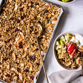 Flatlay tray of tahini granola with a side bowl filled with granola and fruit
