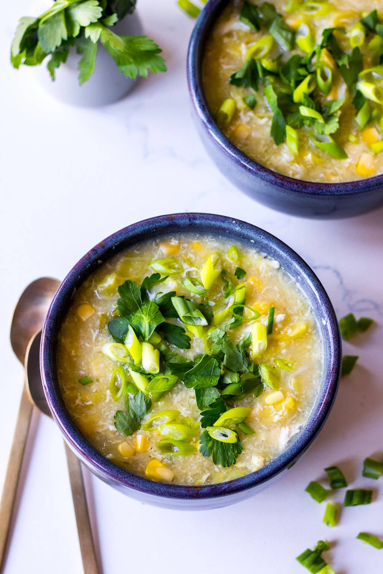Bowl of chicken sweet corn soup with spring onion