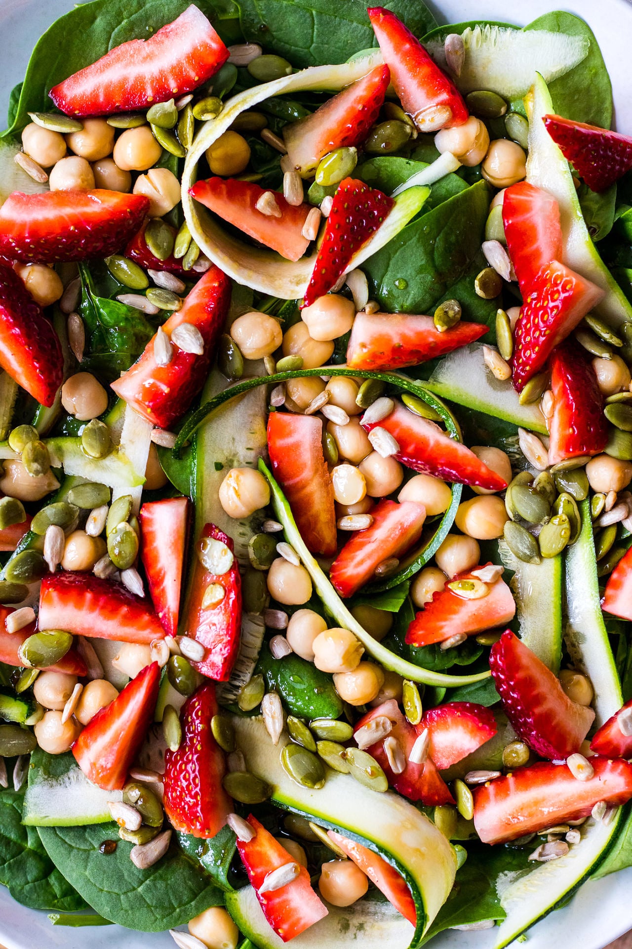 Close up of spinach, zucchini, chickpea and strawberry salad