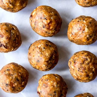 energy balls made with peanut butter, dates, oats and chia seeds, laid out on baking paper