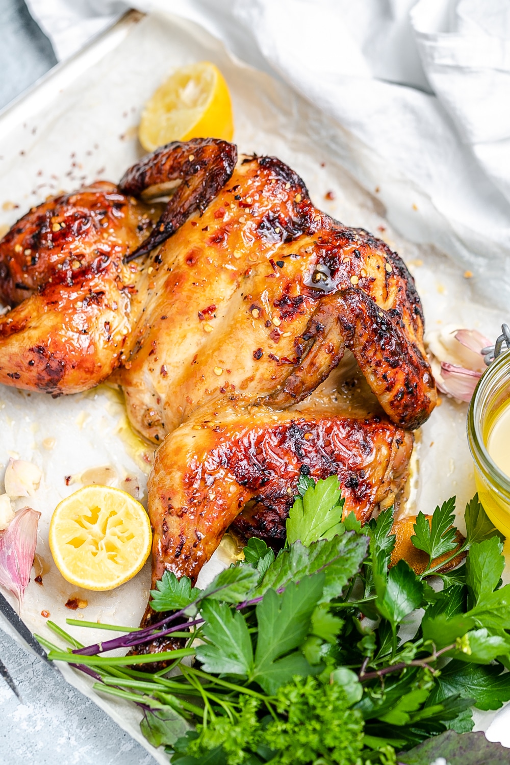 Butterflied roast chicken with lemon, chilli and garlic, fresh herbs to the side