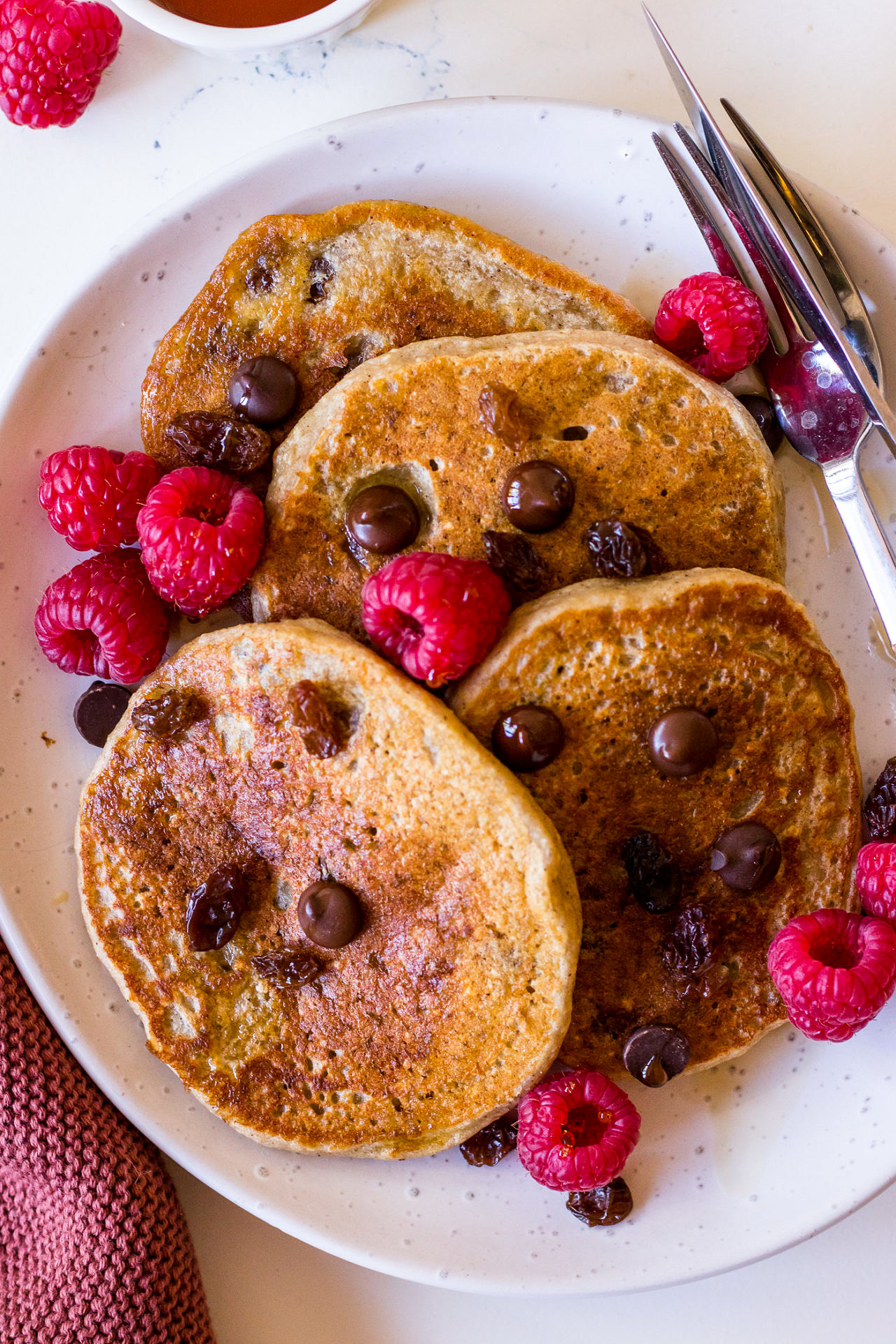 Vegan pancakes made with Happy Way protein powder served with berries, choc chips and maple syrup
