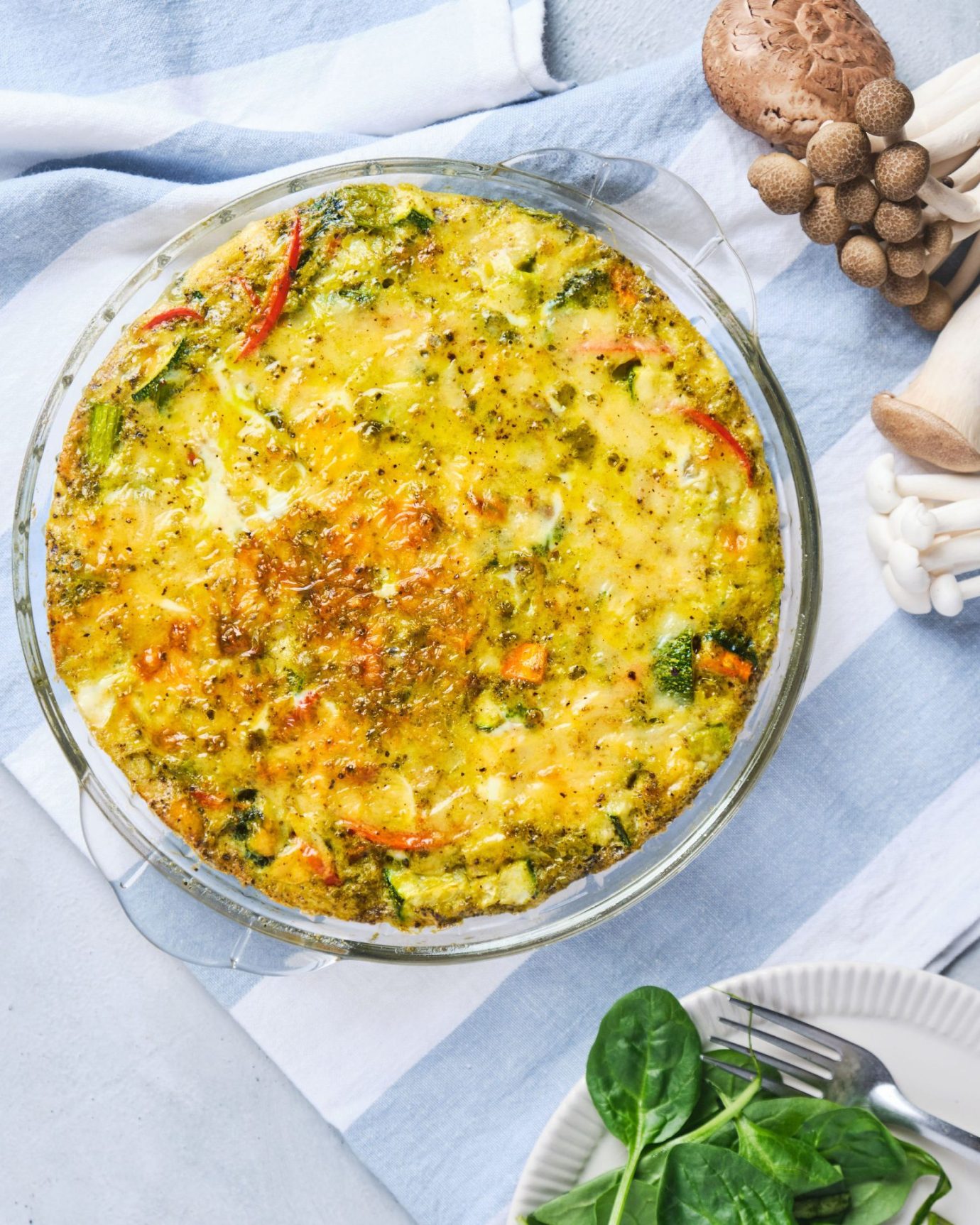 image of a pesto vegetable frittata topped with melted cheese