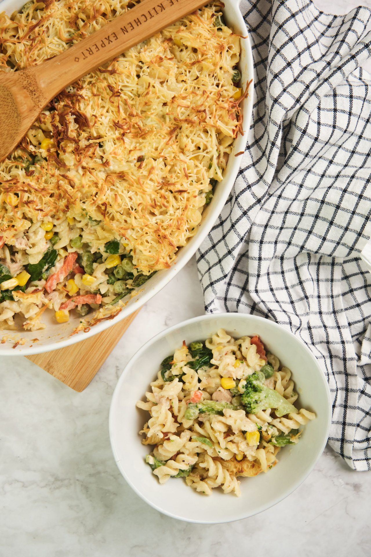 Tuna pasta casserole with vegetables in a large baking dish with a smaller serving in a bowl