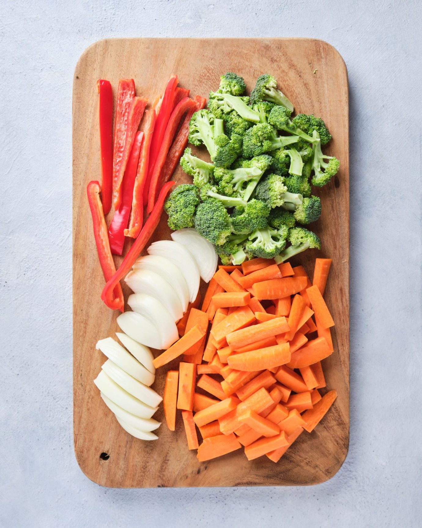 Chopped vegetables on a wooden chopping board