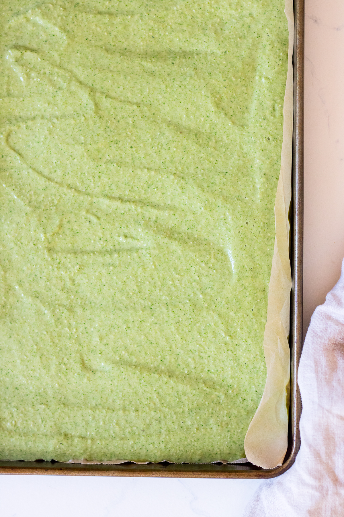 Image of green pancake batter in a rectangular sheet pan