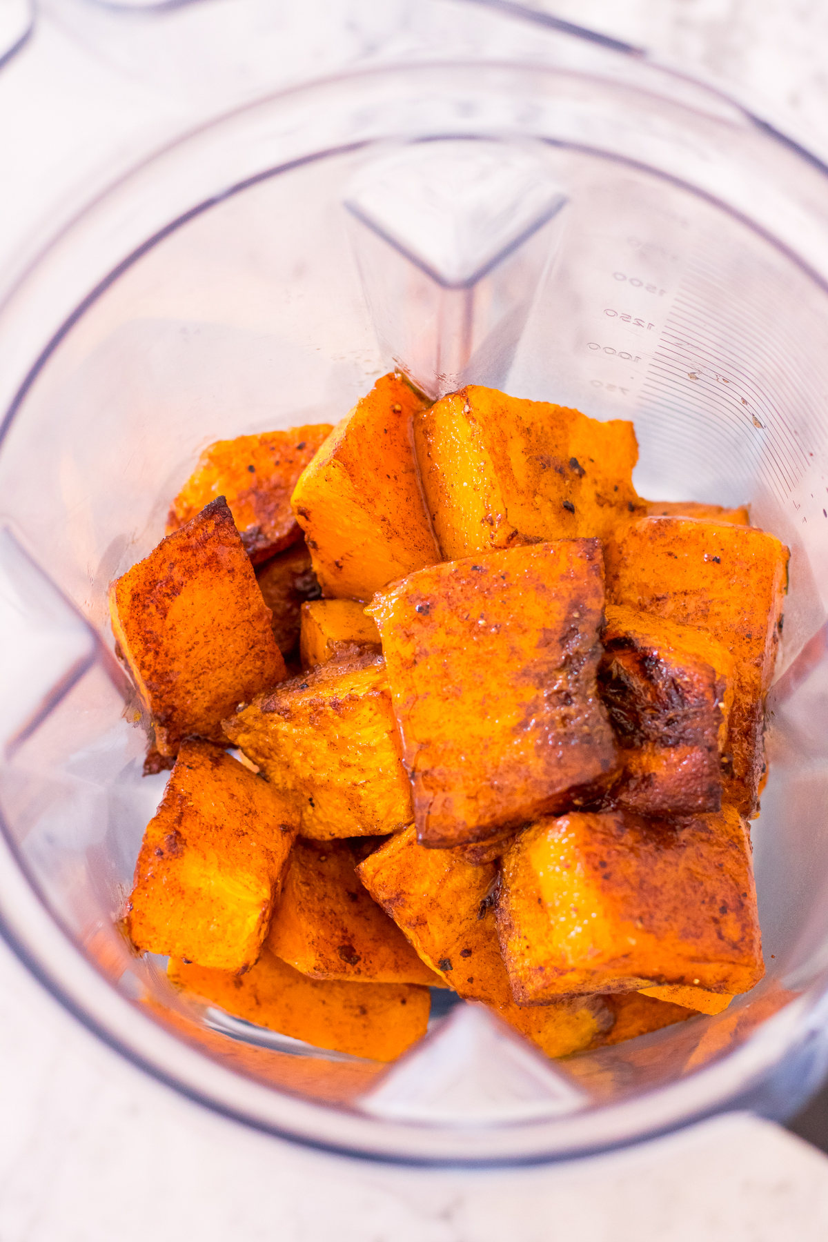 Image of roasted pumpkin chunks in a blender jug.