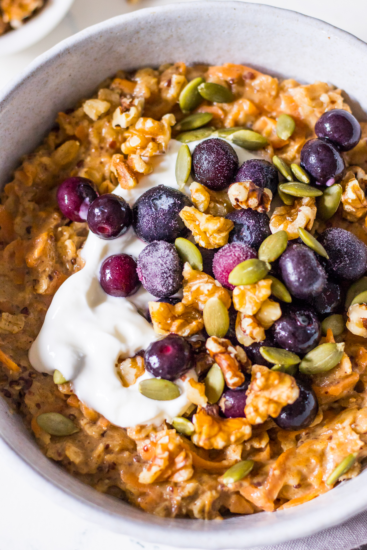 Close up image of carrot cake oatmeal with berries