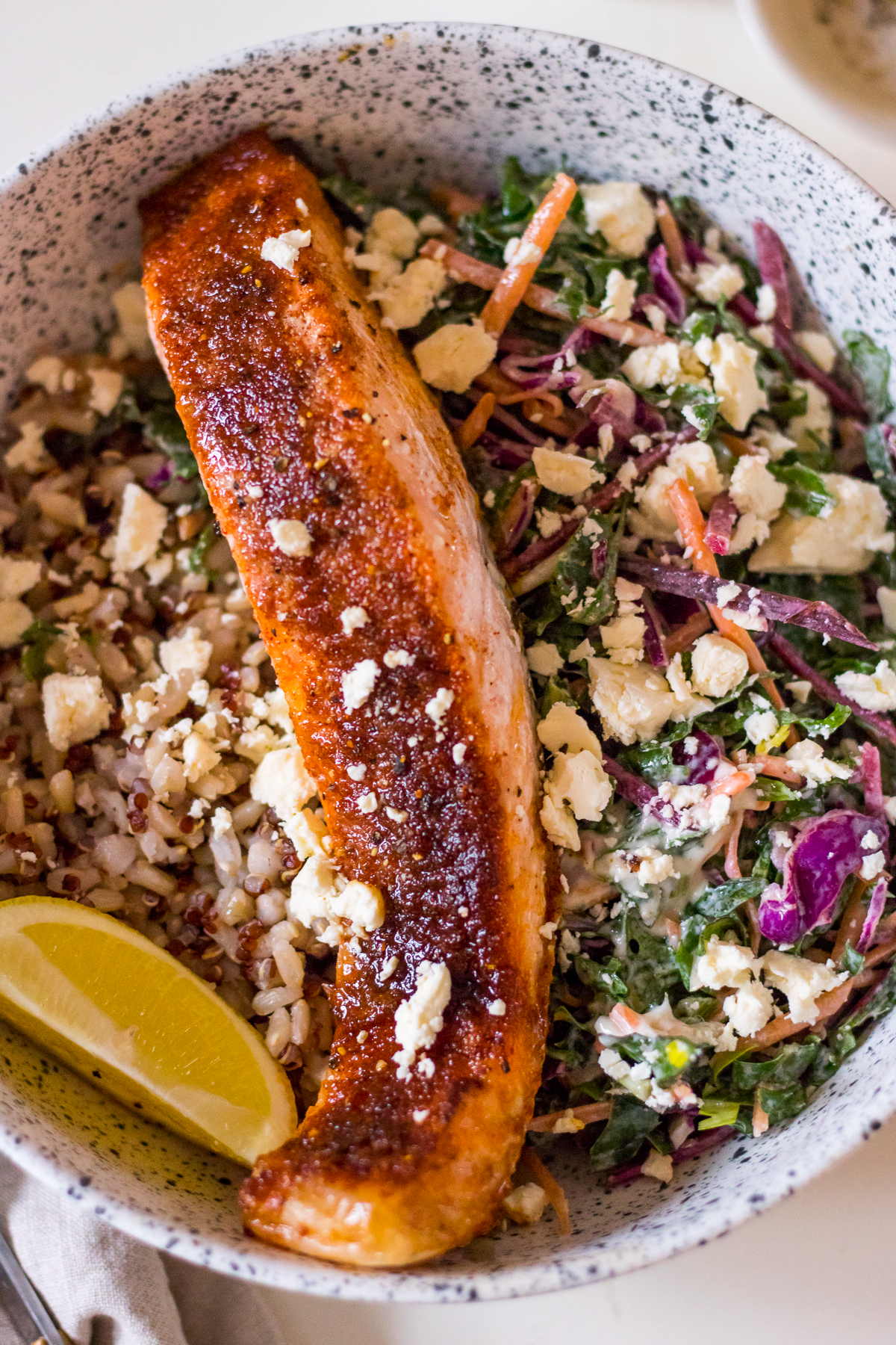 Brown sugar glazed salmon fillet in a dinner bowl with slaw