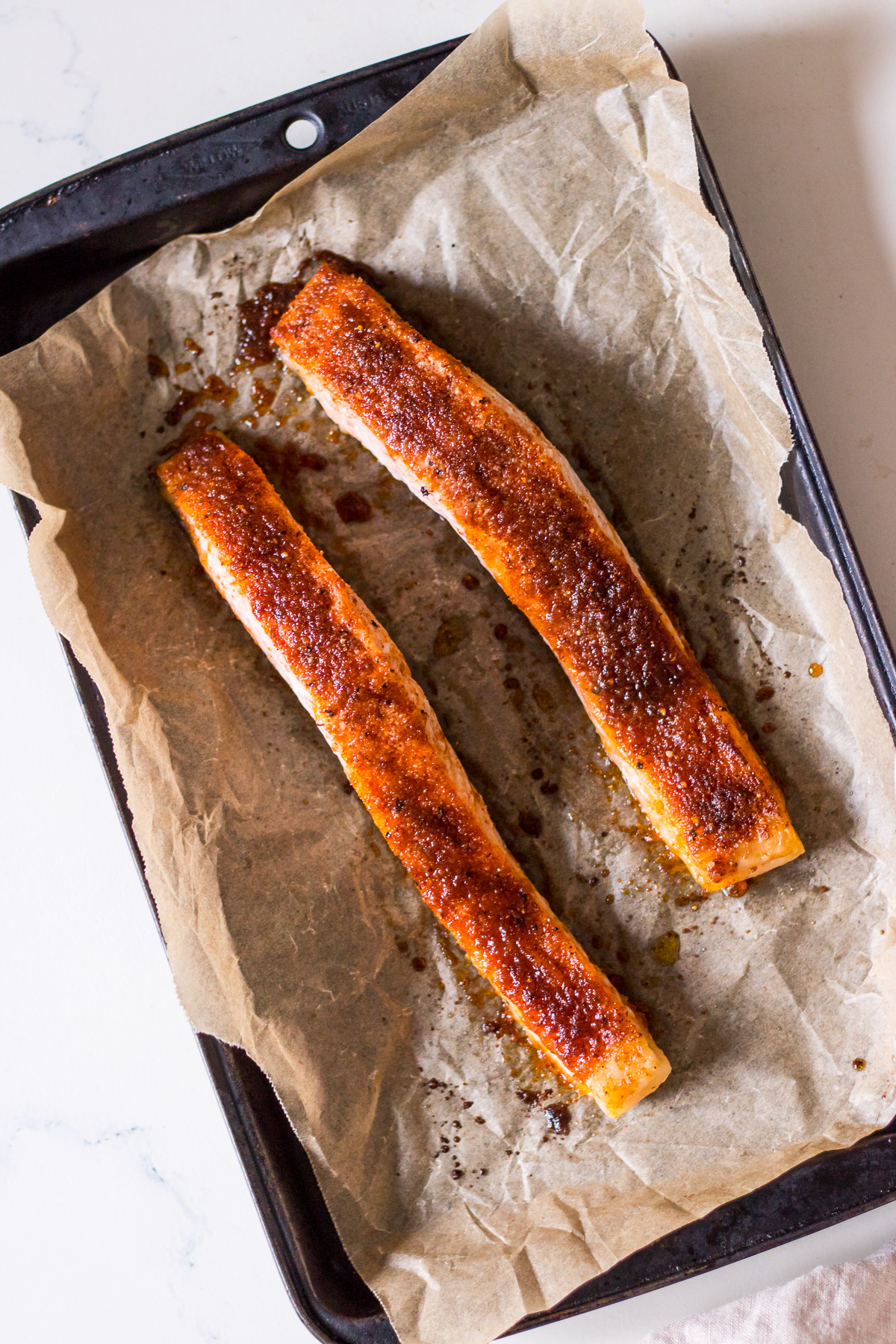 Image of brown sugar baked salmon fillets on a metal baking tray