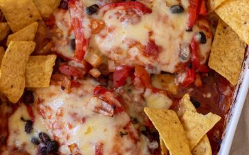 Healthy Chicken Taco Bake with bean mix, tomatoes, melted cheese and tortilla chips