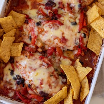 Healthy Chicken Taco Bake with bean mix, tomatoes, melted cheese and tortilla chips