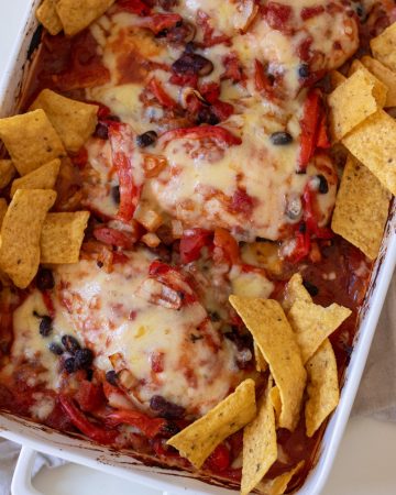 Healthy Chicken Taco Bake with bean mix, tomatoes, melted cheese and tortilla chips