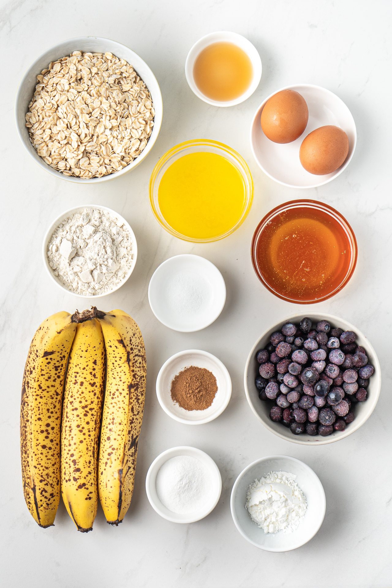 Ingredients needed to make healthy banana blueberry oat muffins.