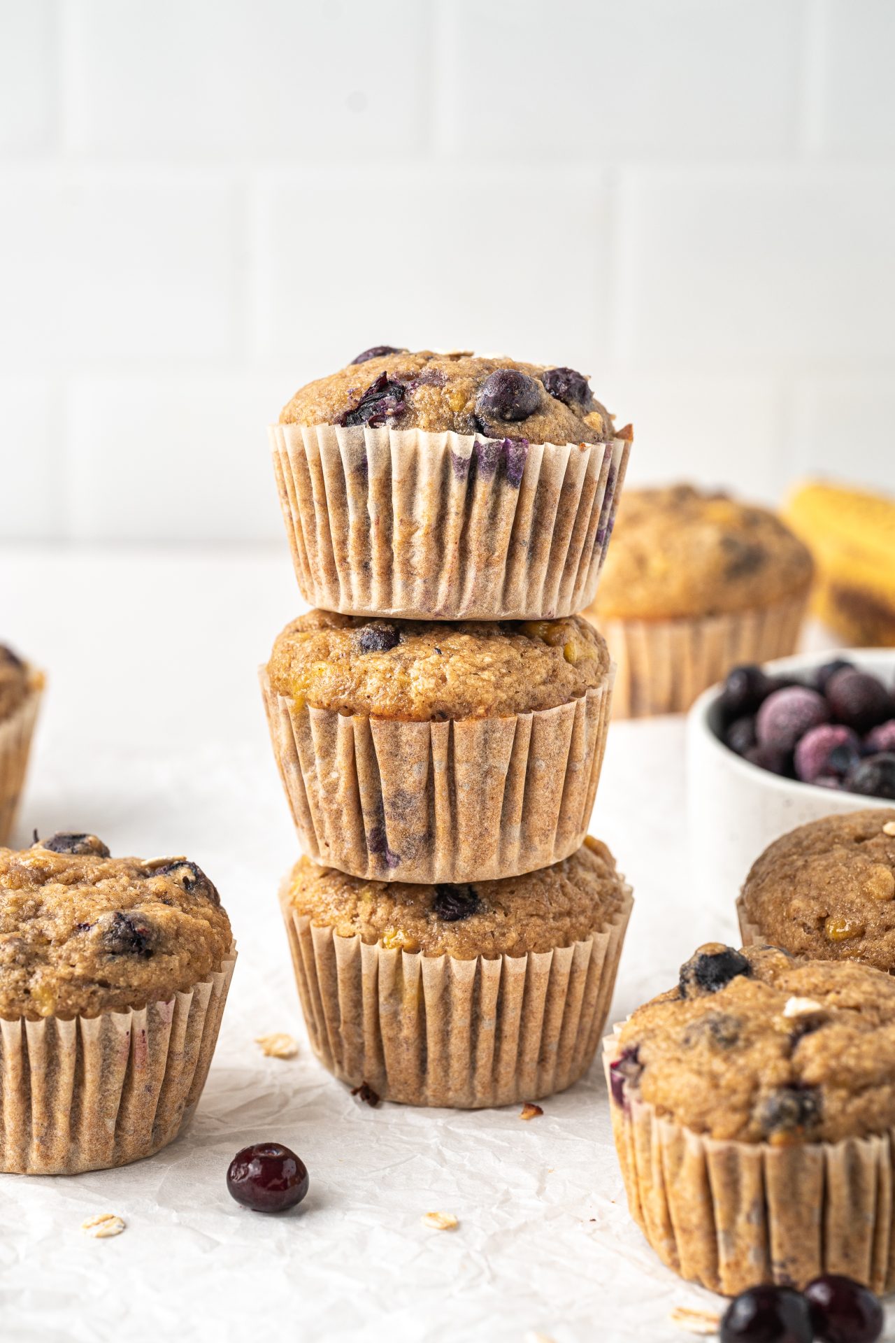 Healthy banana blueberry oat muffins arranged in a tower stack.