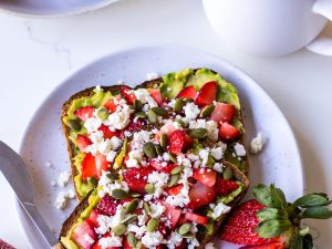 Strawberry avocado toast with a cup of tea