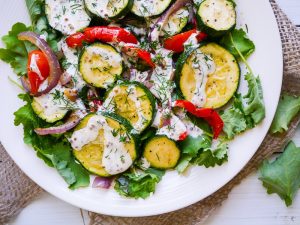 Roasted Zucchini Salad with Yoghurt Dill Dressing - This healthy roasted zucchini salad recipe is quick and easy to prepare. Gluten free & grain free, topped with a creamy yoghurt-dill dressing! Recipe via wordpress-6440-15949-223058.cloudwaysapps.com
