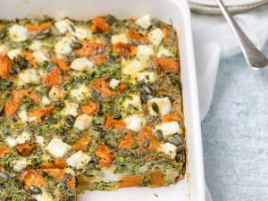 Sweet potato, broccoli and feta frittata in a white rectangular baking dish