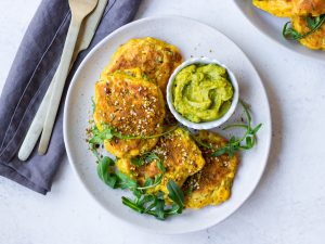 Gluten Free Corn Fritters arranged with rocket on grey ceramic plate | Nourish Every Day Blog